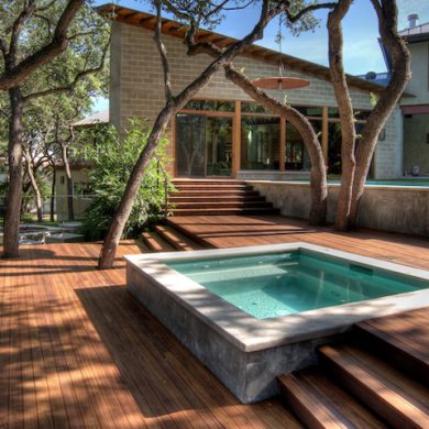 Custom built Merbau spa deck integrating existing mature trees