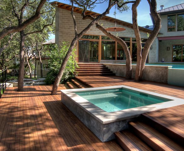 Custom built Merbau spa deck integrating existing mature trees